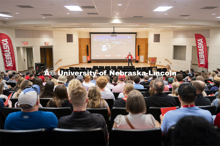 High school students sit alongside their parents as they are welcomed by Associate Director of Admissions Kayla Tupper during Red Letter Day in the amphitheater in the Nebraska Union. September 13, 2024. Photo by Jordan Opp for University Communication.